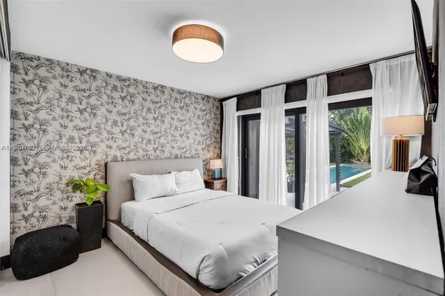 a bedroom with a bed and a large window