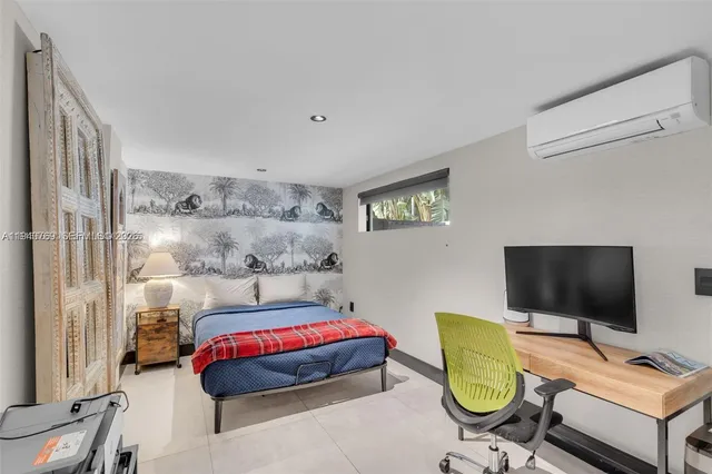 a bedroom with a bed and flat screen tv