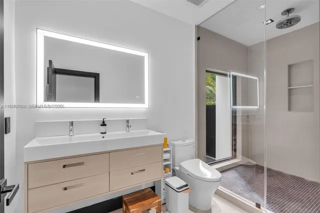 a bathroom with a toilet sink and mirror