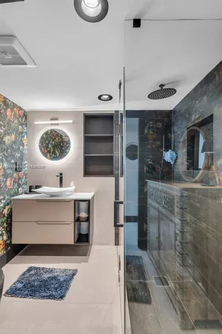 a view of living room kitchen with stainless steel appliances cabinets and fireplace
