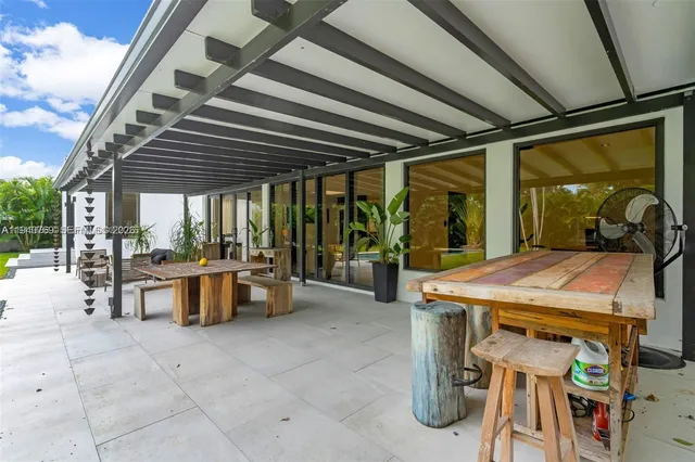 a view of a patio with table and chairs and potted plants