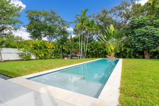 a view of a swimming pool with a yard