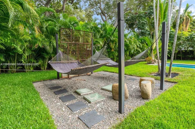 a view of a chair and table in the garden