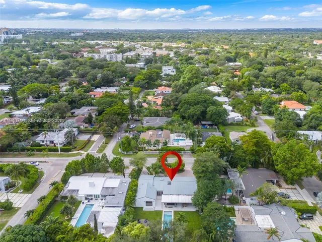 an aerial view of residential houses with outdoor space and street view