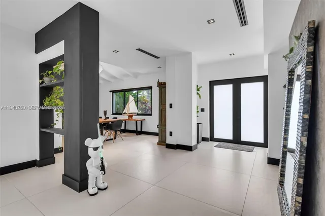 a view of a livingroom with furniture and a hallway