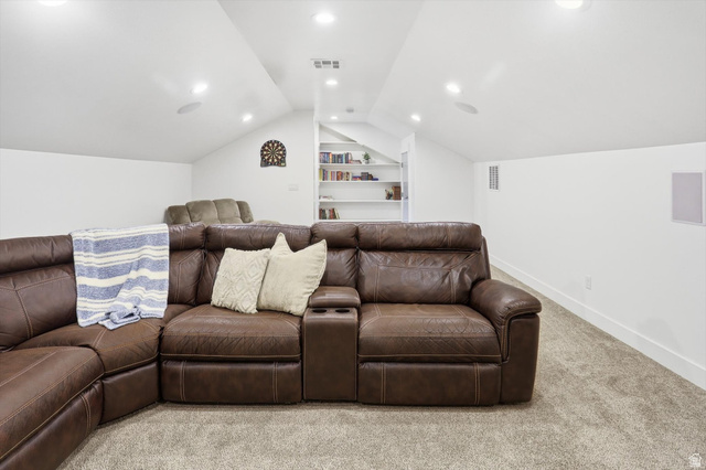 1009 High Creek Road Cove, UT 84320 - Photo 49 of 79 Home theater room featuring carpet, built in shelves, vaulted ceiling, and recessed lighting
