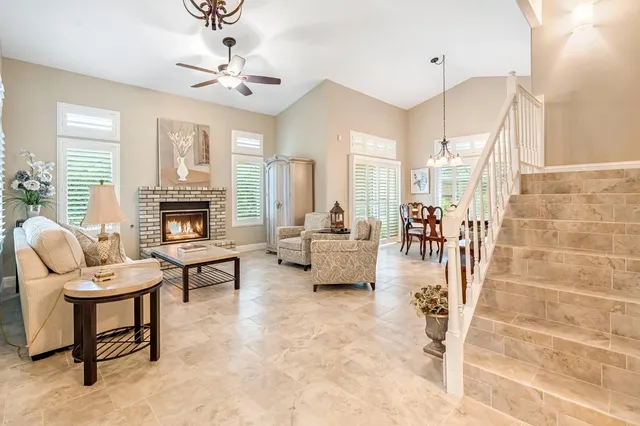 a living room with furniture fireplace and a chandelier