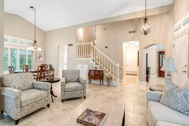 a living room with furniture and a chandelier