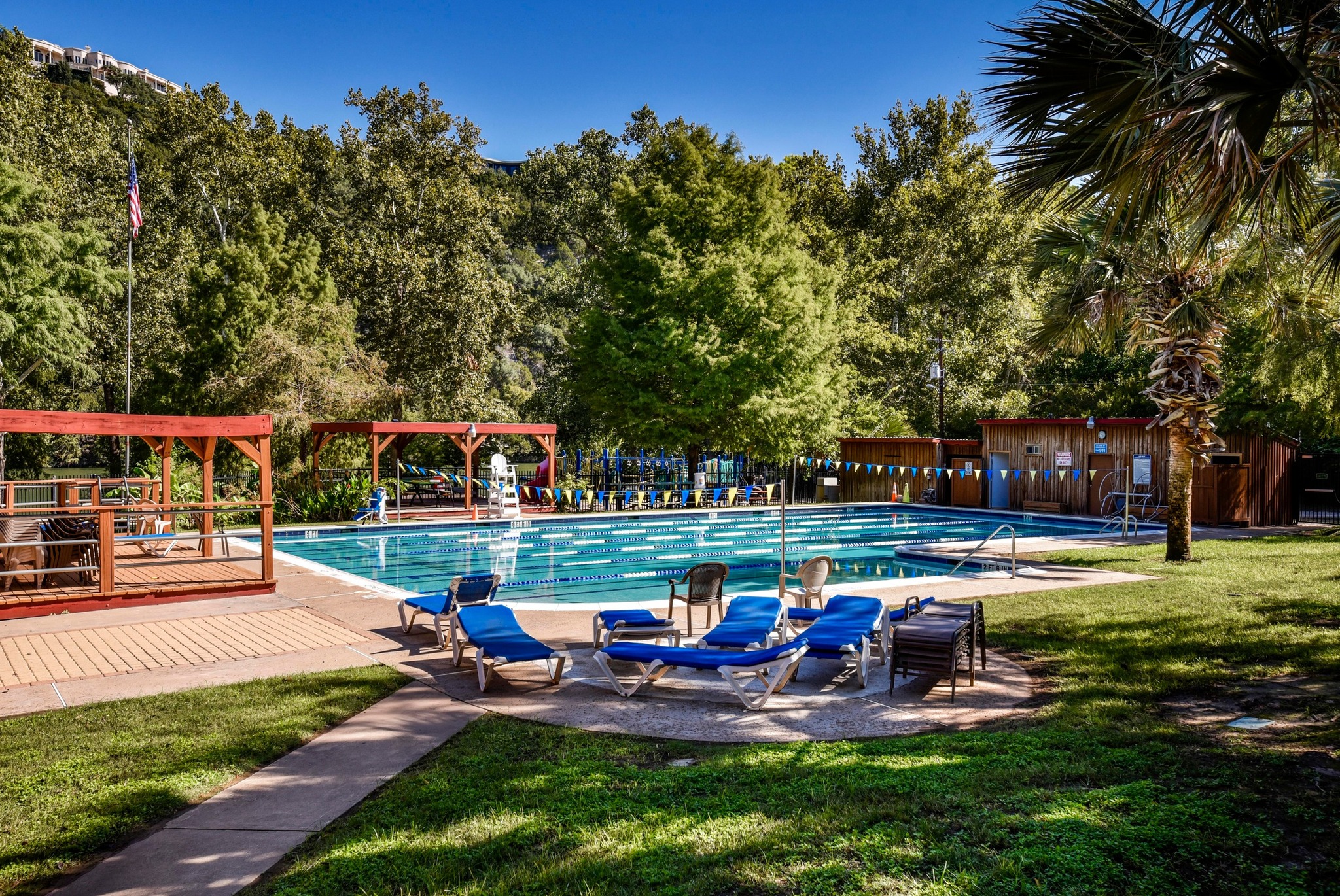 1107 Bowie Road Austin, TX 78733 - Photo 39 of 40 An inviting community pool beckons, surrounded by mature trees and lush green spaces.