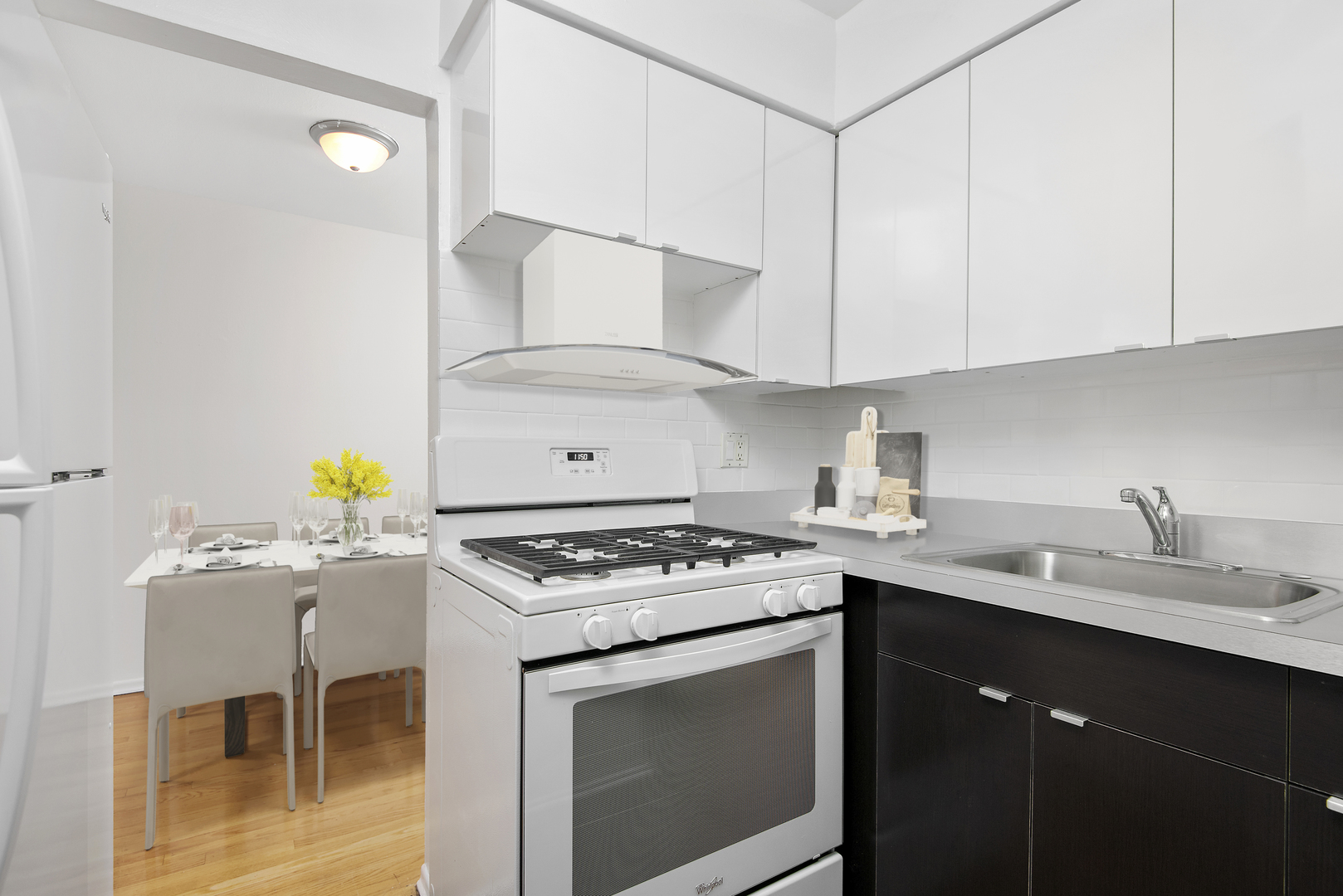 450 West Melrose Street, Unit 239 Chicago, IL 60657 - Photo 4 of 10 a kitchen with stainless steel appliances a stove a sink and a refrigerator