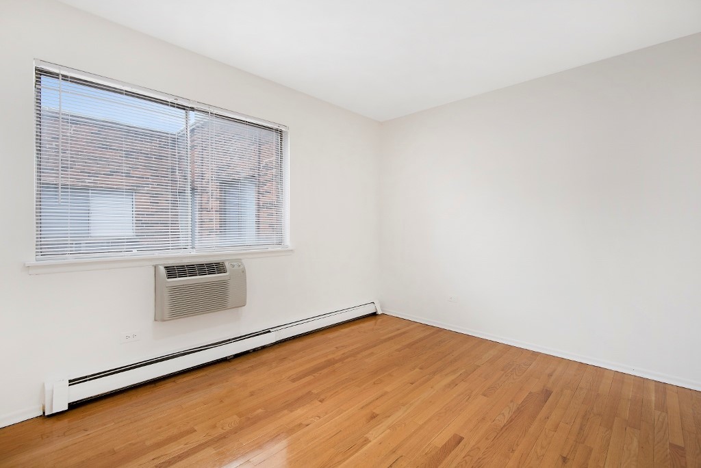 450 West Melrose Street, Unit 239 Chicago, IL 60657 - Photo 8 of 10 a room with a wooden floor and white doors