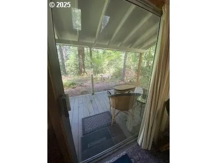 a view of a room with a floor to ceiling window and outside view