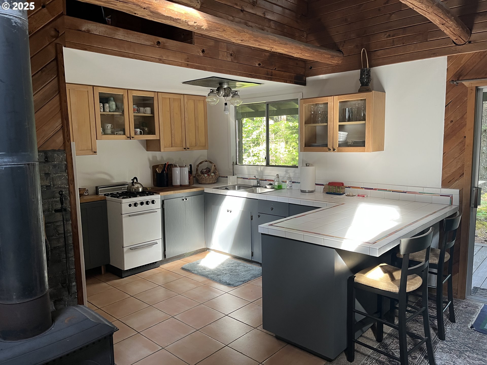 64 Northwoods Cougar, WA 98616 - Photo 20 of 22 a kitchen with a sink a stove cabinets and a dining table
