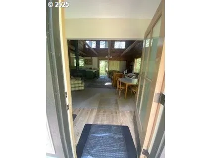 a view of a hallway with furniture and front door