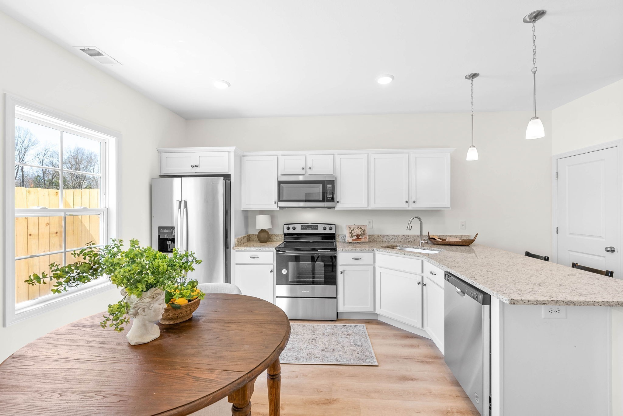 940 Britton Springs Road, Unit 403 Clarksville, TN 37042 - Photo 7 of 15 a kitchen with a white center island a sink cabinets and stainless steel appliances