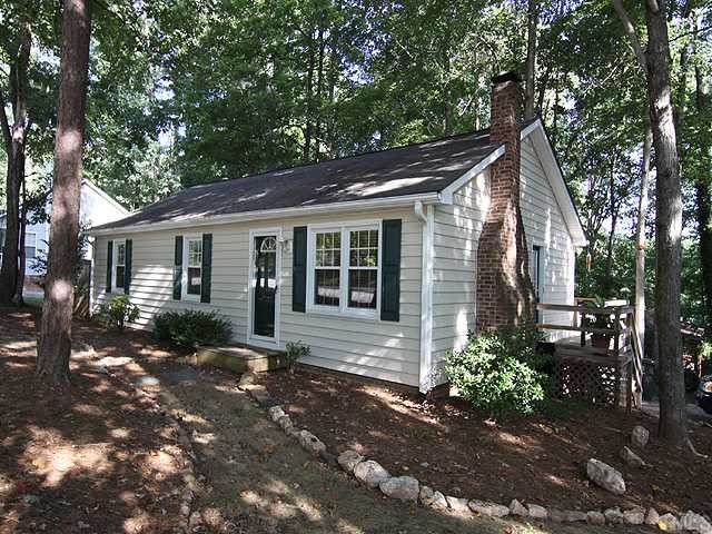 3600 Lynn Road Raleigh, NC 27613 - Photo 1 of 12 a front view of a house with a garden