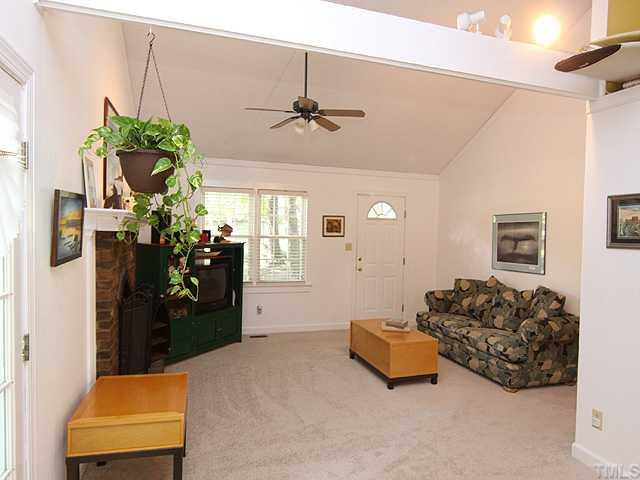 3600 Lynn Road Raleigh, NC 27613 - Photo 3 of 12 a bed room with furniture and a chandelier