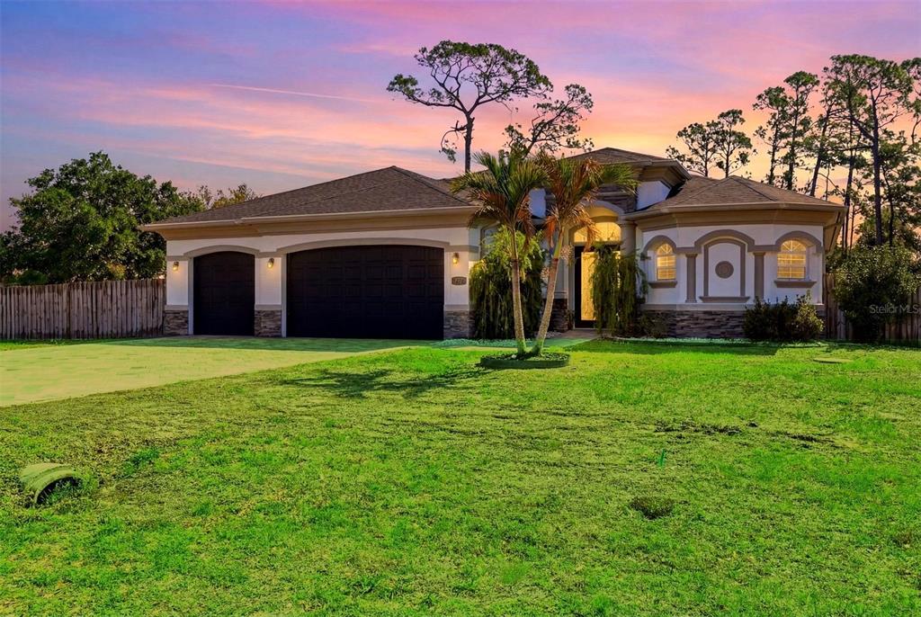 1026 Broadview Street Port Charlotte, FL 33952 - Photo 1 of 1 a front view of a house with a garden and yard