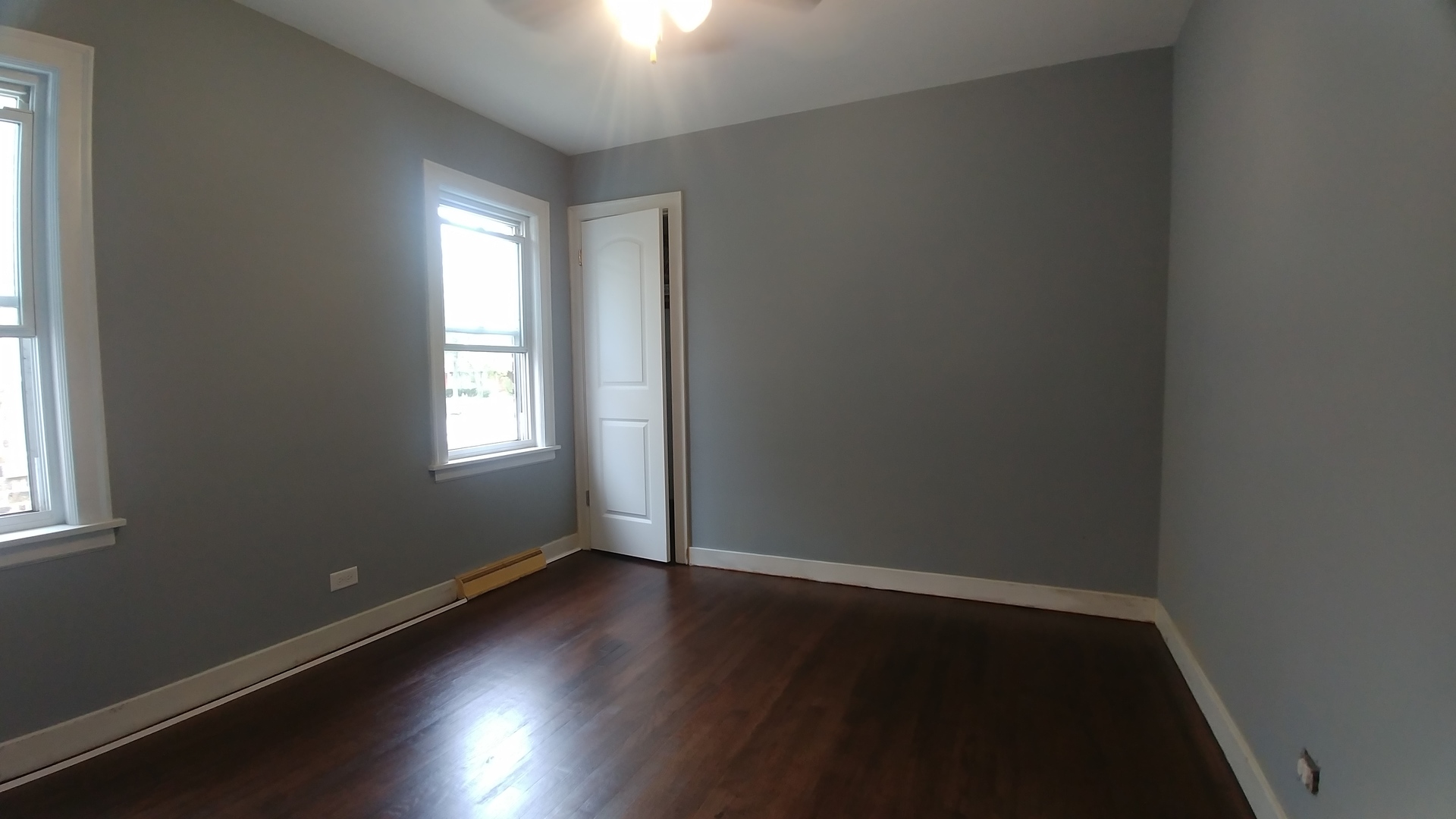 202 7th Place Chicago Heights, IL 60411 - Photo 4 of 11 an empty room with wooden floor and windows