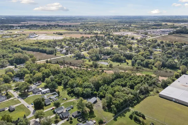 an aerial view of residential houses with outdoor space