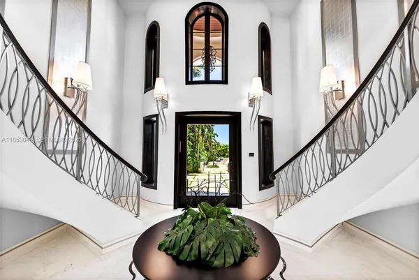 a living room with furniture chandelier and a large window
