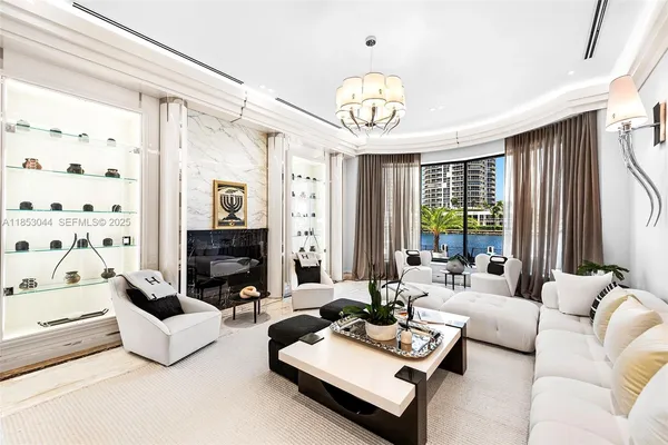 a living room with furniture and a chandelier
