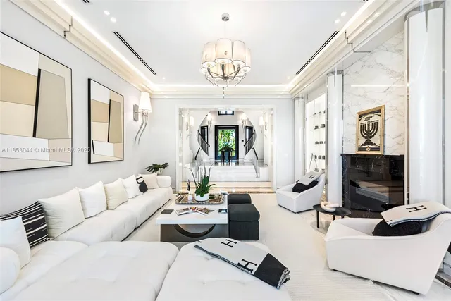 a living room with furniture and large windows