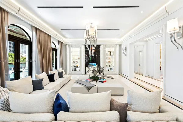 a living room with furniture and a chandelier