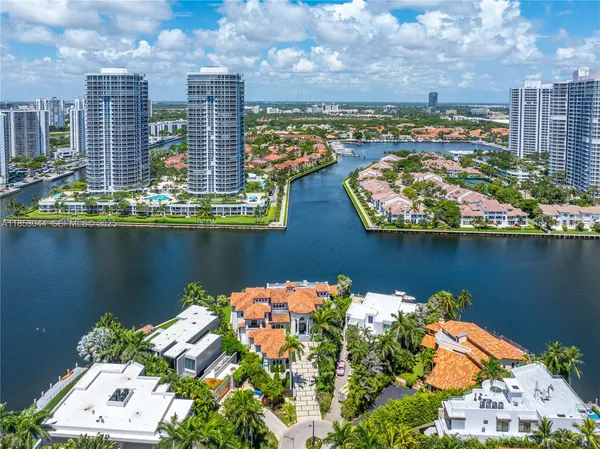an aerial view of a city with lots of residential buildings lake and ocean view