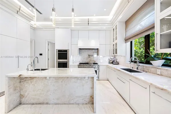 a bedroom with a large bed and a potted plant