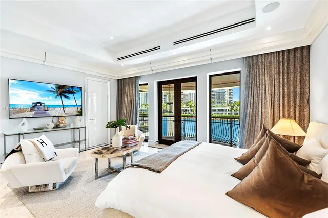 a view of a building with a swimming pool and sitting area