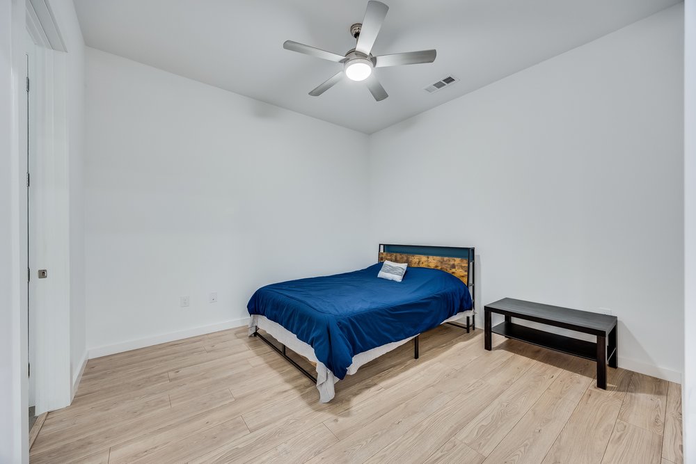4801 Springdale Road, Unit 2107 Austin, TX 78723 - Photo 19 of 26 a room with a bed and a chandelier