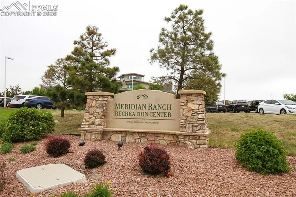 a view of a lake with a garden and swimming pool