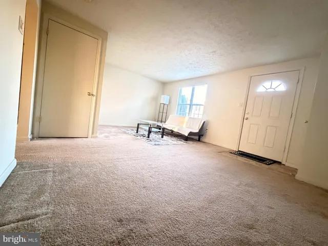 a view of a room with furniture and a window