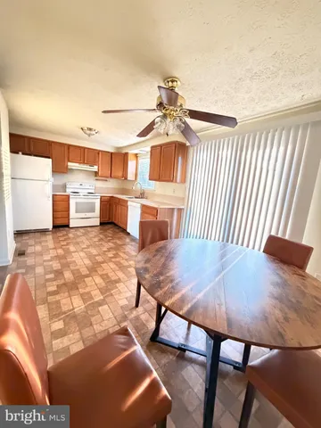 a view of a dining room with furniture and a rug