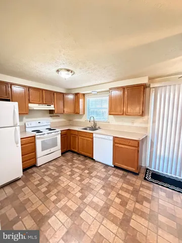 a kitchen with stainless steel appliances a sink and cabinets