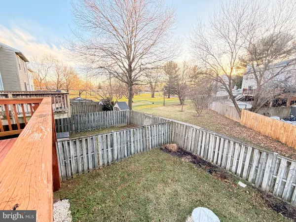 a view of a balcony with wooden fence and floor