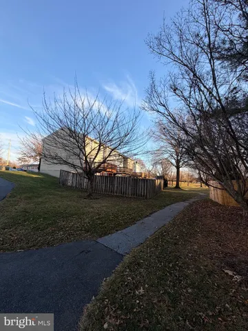 a view of a yard with plants and trees