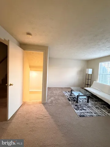 a living room with furniture a lamp and a window