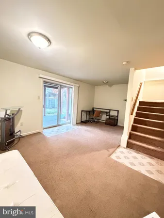 a view of a livingroom with furniture and a ceiling fan