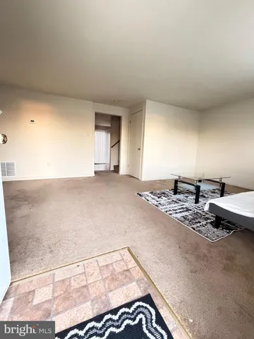 a view of a livingroom with furniture and a rug