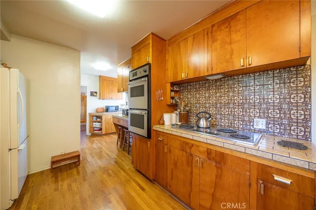 a kitchen with granite countertop sink and cabinets