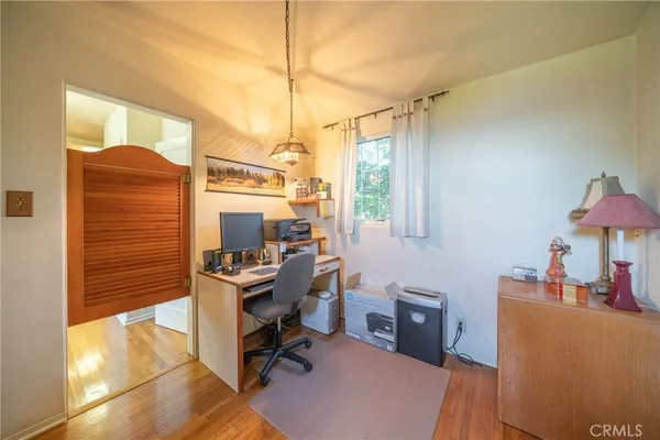 a view of a workspace with furniture and a window