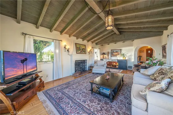 a living room with furniture a rug and a flat screen tv