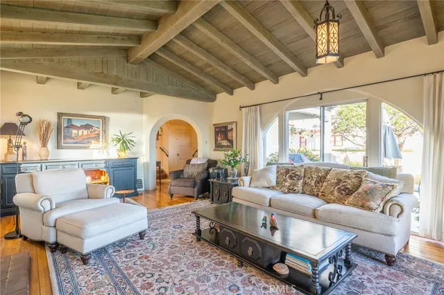 a living room with furniture a rug and a large window