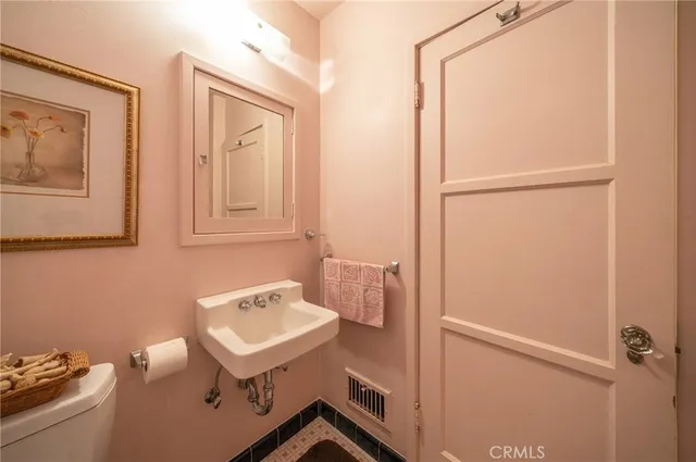 a bathroom with a sink a mirror and a toilet