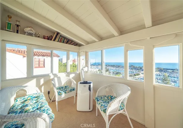 a living room with furniture and floor to ceiling windows
