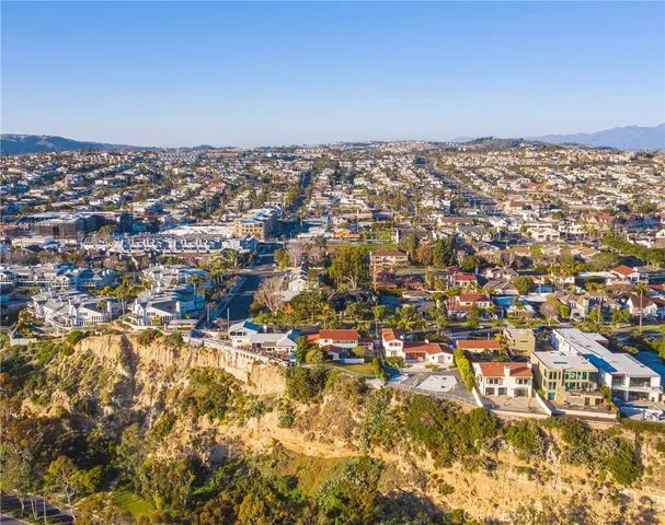an aerial view of a residential houses with city view