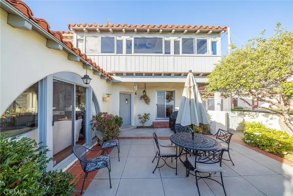 a view of a house with backyard sitting area and garden