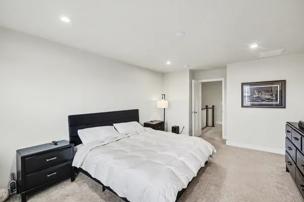 a bedroom with a bed and a night stand